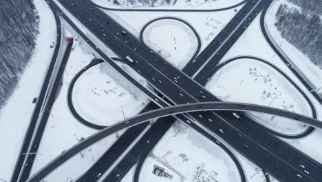 aerial view of a freeway intersection snow-covered in winter.