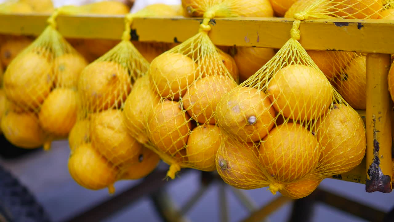 Lemons in Net Bags at a Market
