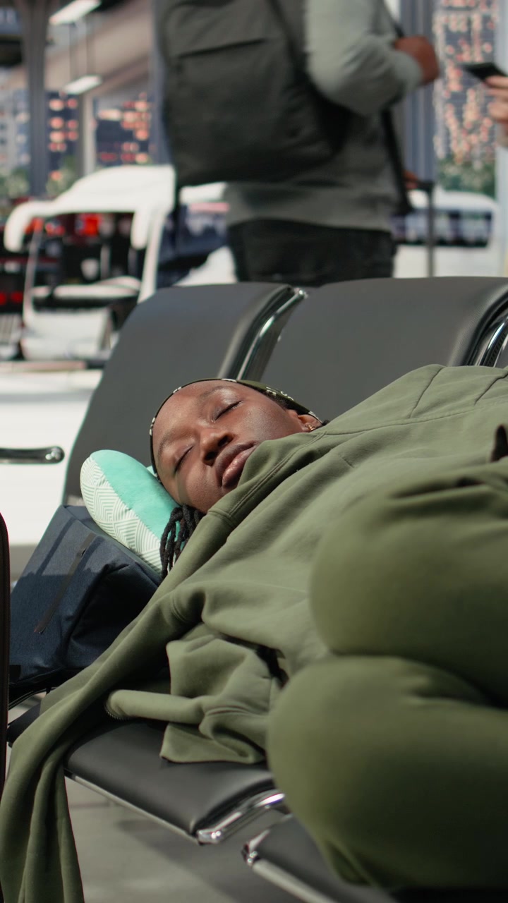 Young Woman Sleeping on Airport Terminal Chairs