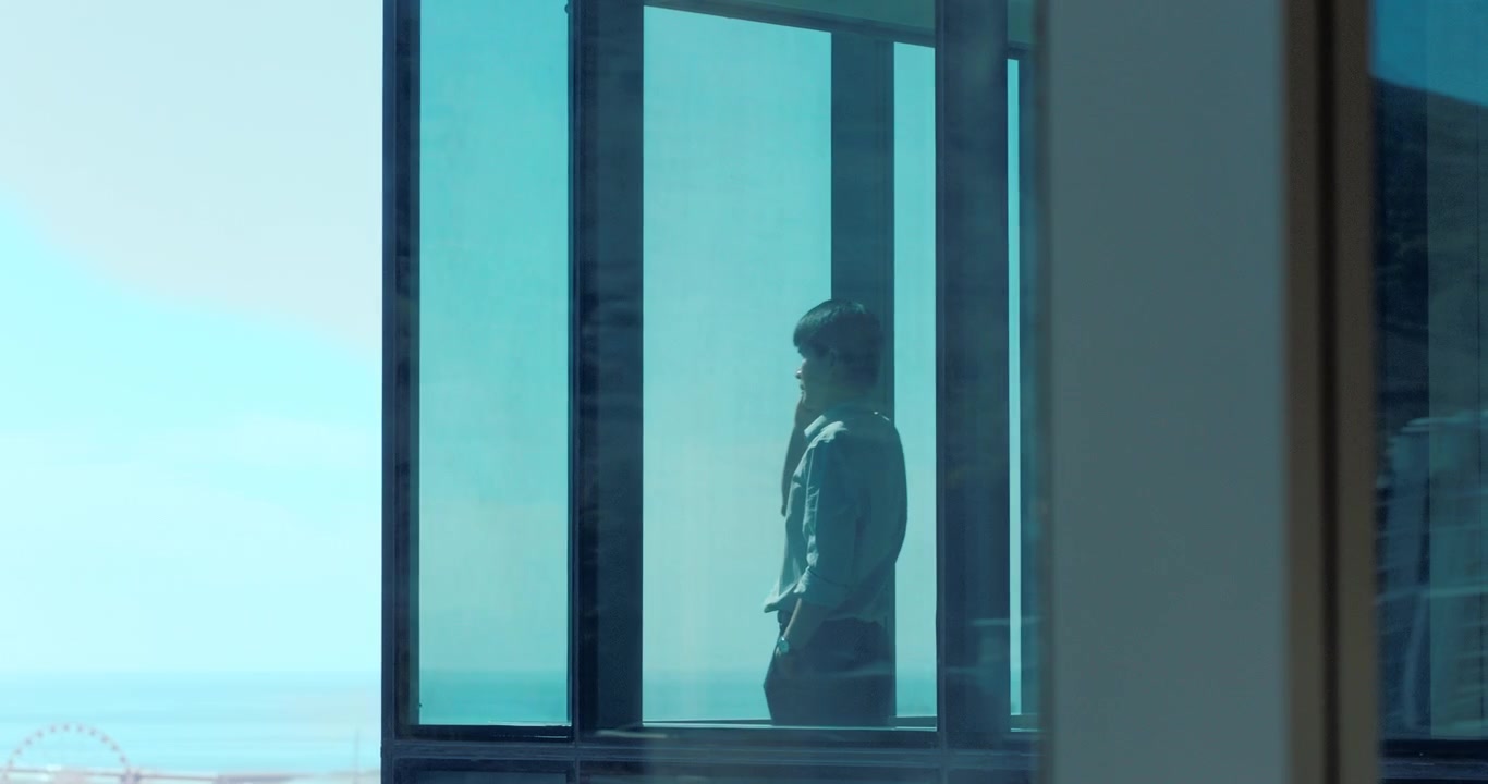 Businessman Standing by Office Window Looking at View