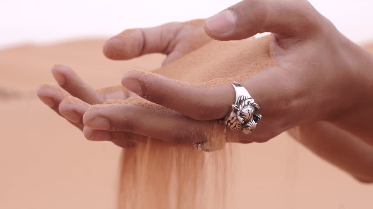 male hands playing with sands