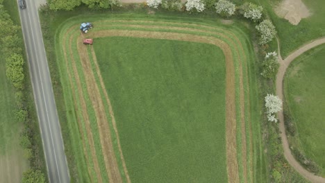 Cutting-Of-Grass-Field-By-A-Tractor-In-Wexford,-Ireland---aerial-top-down