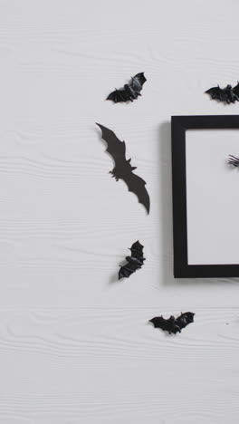 vertical video of black frame with bats with copy space on white background