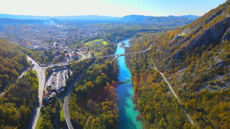 Stunning-aerial-4K-drone-footage-of-Solkan-arch-bridge-over-the-Soča-river,-a-majestic-stone-marvel-located-in-western-Slovenia