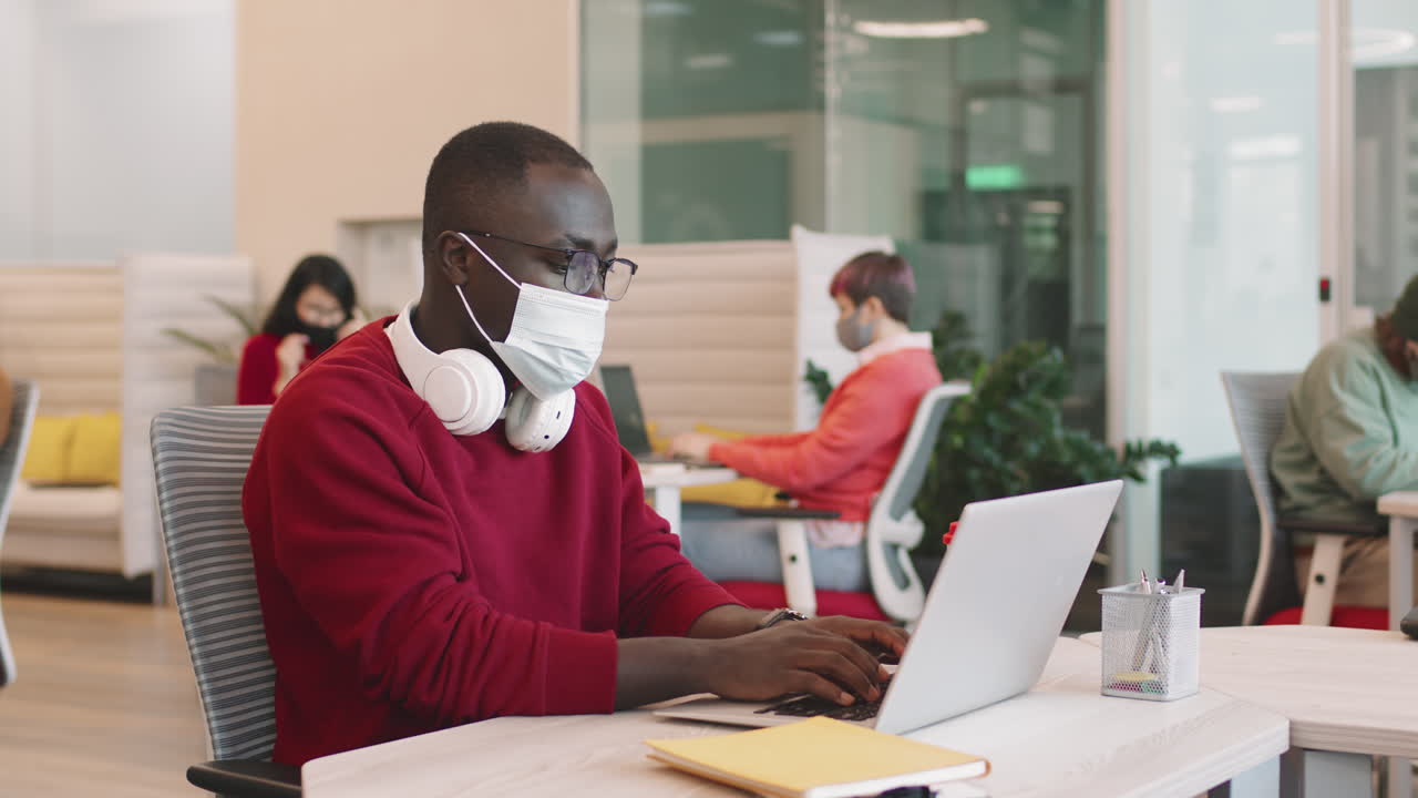 Black Businessman in Face Mask Working in Office