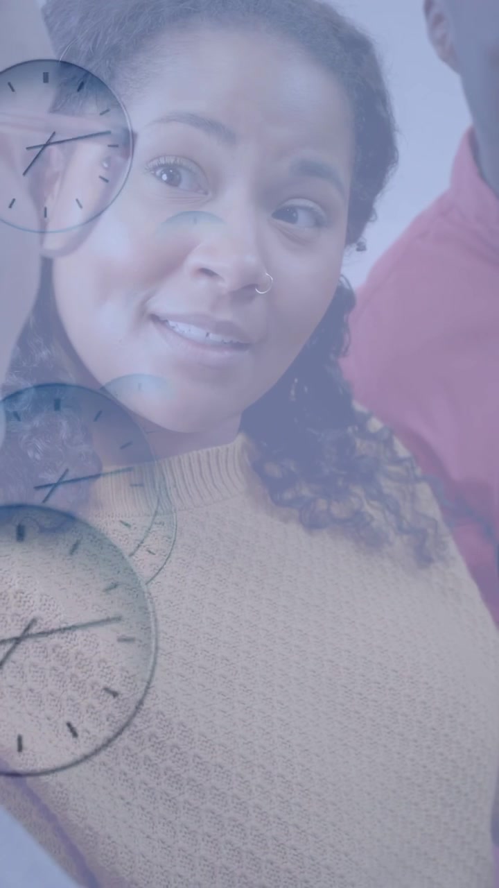 Vertical video: Team of three leaning toward tablet, woman leading business talk as clocks overlay