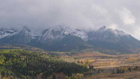 Beautiful-aerial-view-of-snow-capped-high-mountain-peaks-and-native-forest,-Telluride,-Colorado