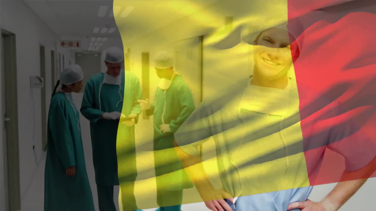 animación de la bandera de bélgica ondeando sobre un cirujano caucásico sonriente de pie en el pasillo del hospital