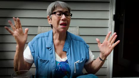 older women talking to friend showing many emotions for happy to sad with her hands