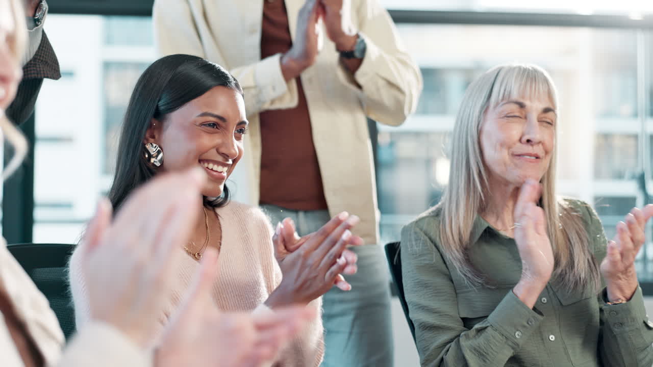 Group of people clapping in an office setting