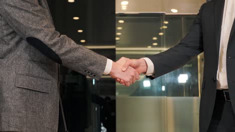 close up handshake business people partners. teamwork. partner ship. shaking hands. two men shake hands, conclude successful contract agreement, sign of support for partnership cooperation, deal.