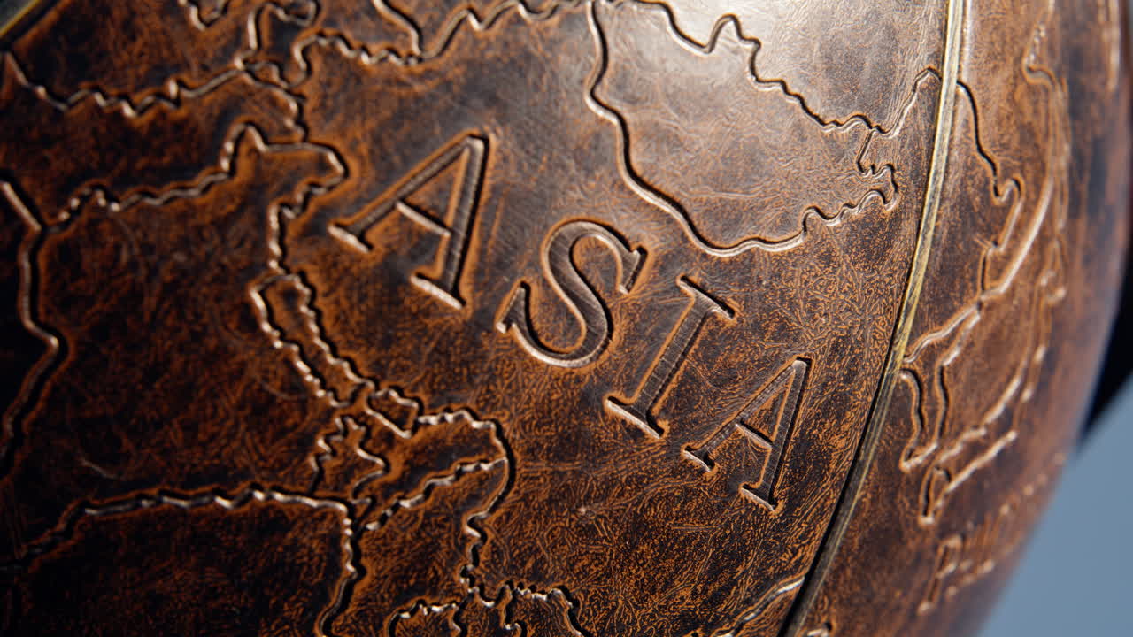 Closeup Asia continent illustrated on old leather globe surface. Mainland part