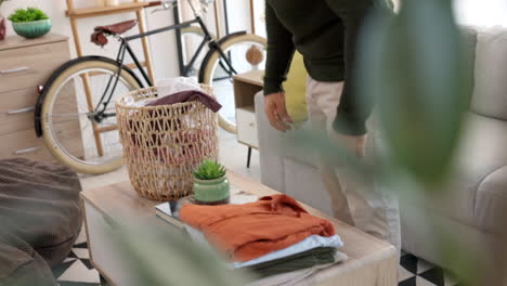 Living-room,-laundry-and-man-with-clean-clothes