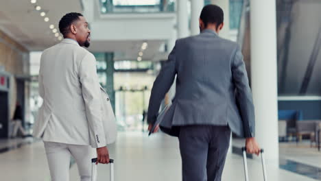 businessmen walking through an airport terminal