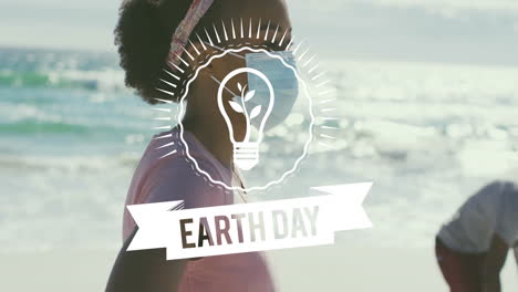earth day animation over people walking on beach
