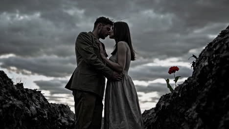 couple kissing under a dramatic sky