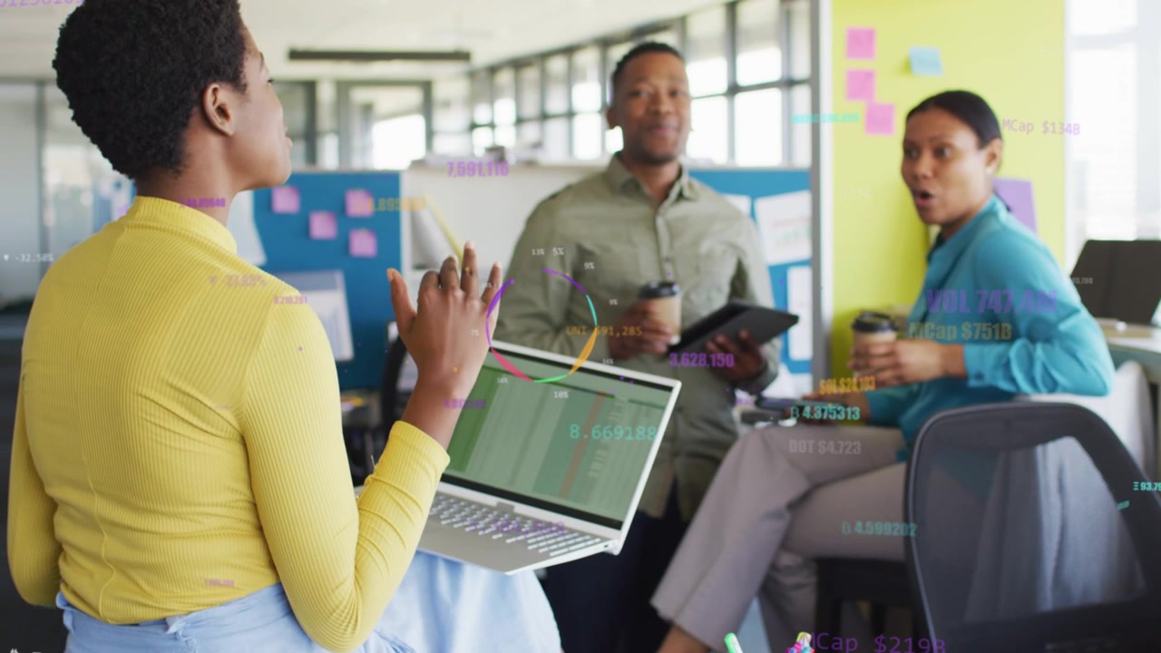 Woman in yellow sharing laptop chart in office meeting, tapping screen and animating graphs