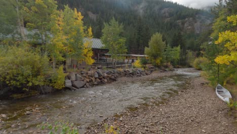 Steam-powered-train-returning-to-Colorado-Mountain-station-in-the-fall,-handheld