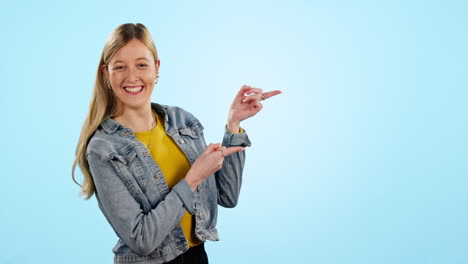 Woman,-point-and-smile-in-studio