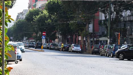 cars and pedestrians on a bustling city street