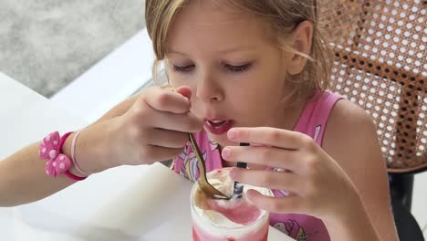 young girl enjoying a strawberry smoothie