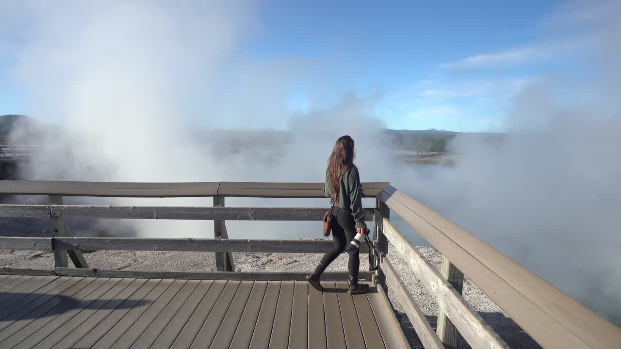 Female Photographer Walking on Lookout Above Steam in Yellowstone National Park, Wyoming USA, Full Frame