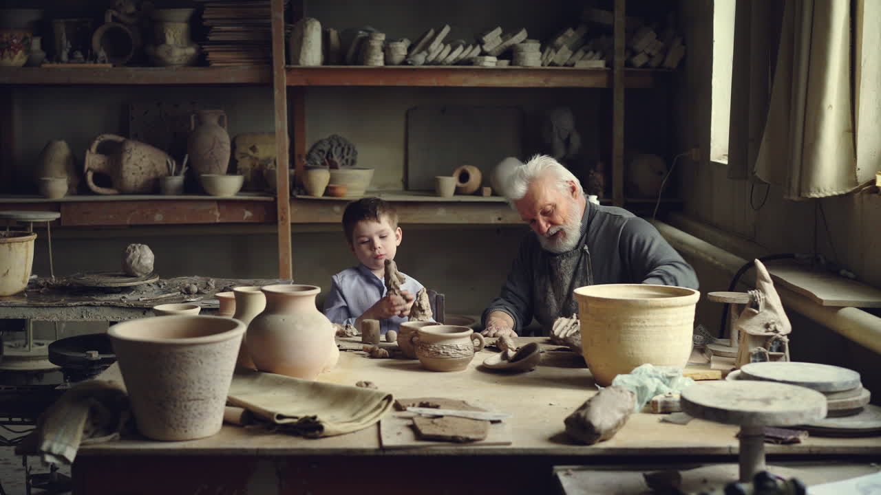 Grandfather and Grandson Working Together in Pottery Workshop