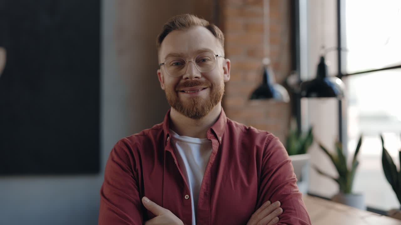 Portrait of a man with glasses and a red shirt