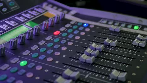 A-detailed-close-up-shot-of-audio-mixer-buttons-being-manipulated-by-a-professional