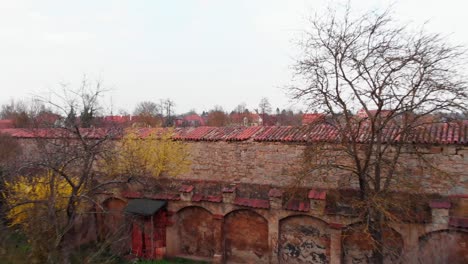 A-drone-flies-out-the-window-of-an-apartment-flying-over-the-city-wall-and-the-river