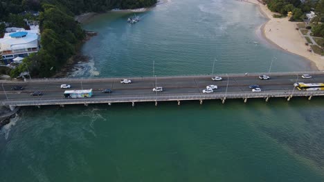 vehicles crossing on tallebudgera bridge over tallebudgera creek in gold coast, qld, australia at daytime