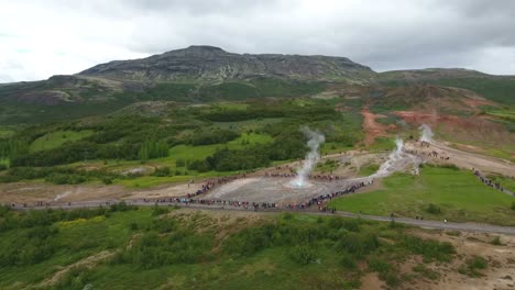 drone view of strokkur geysir eruption - part of golden circle area in iceland