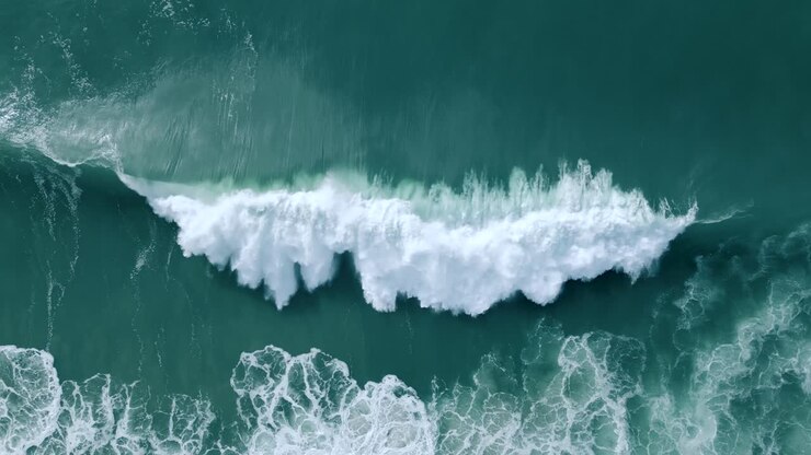 White Waves In The Deep Blue Ocean In Nazare, Portugal