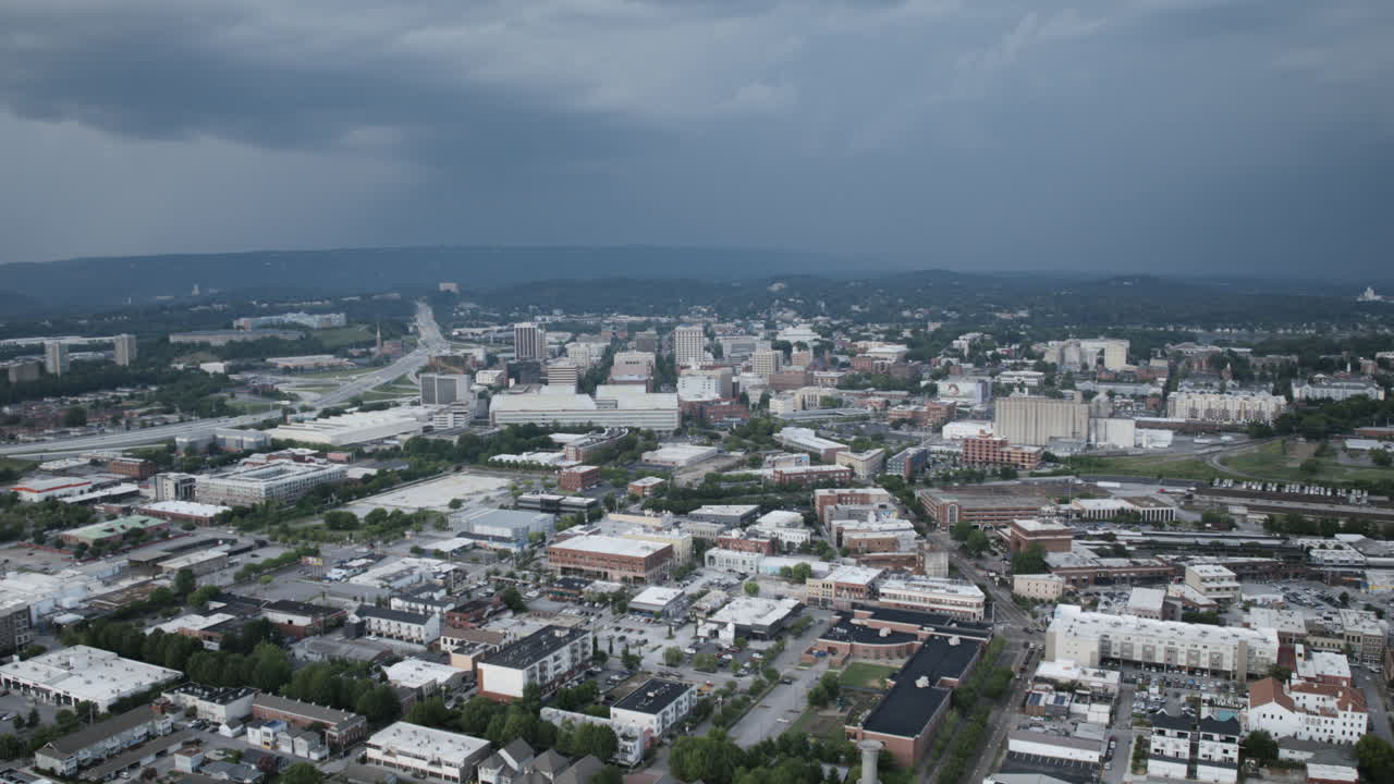 Aerial hyperlapse of downtown Chattanooga during the day with storm in the background