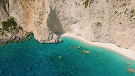 aerial view of a beautiful beach with caves and turquoise water