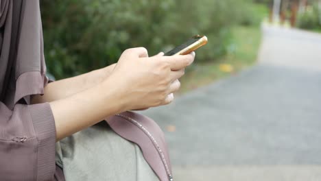 woman using mobile phone in a park