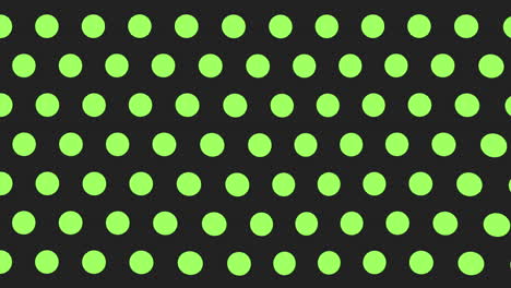 pattern of green and black dots on black background