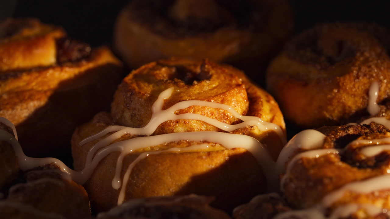 Closeup Of Cinnamon Rolls Glazed With Sweet Icing. rotating shot