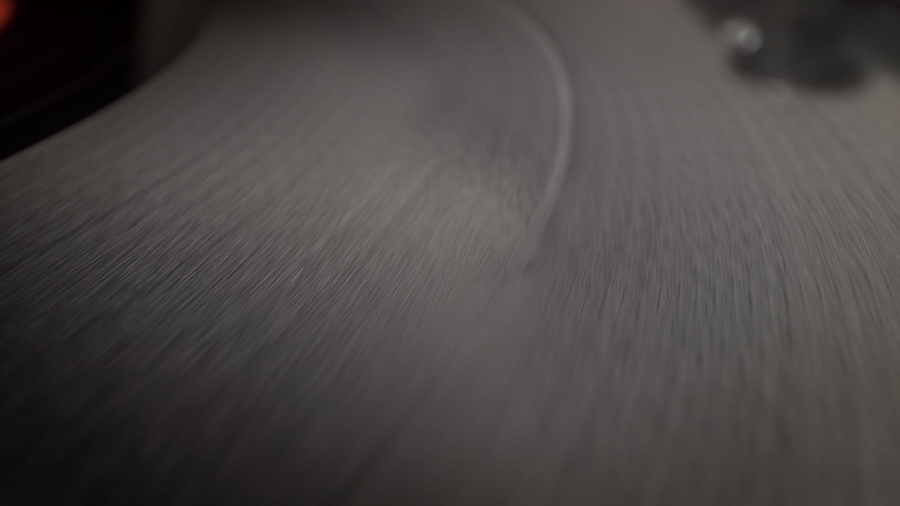 Surface Of Spinning Vinyl Record On The Platter Of A Wooden Turntable, Top View