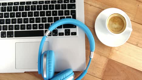 cup of coffee with laptop and headphones