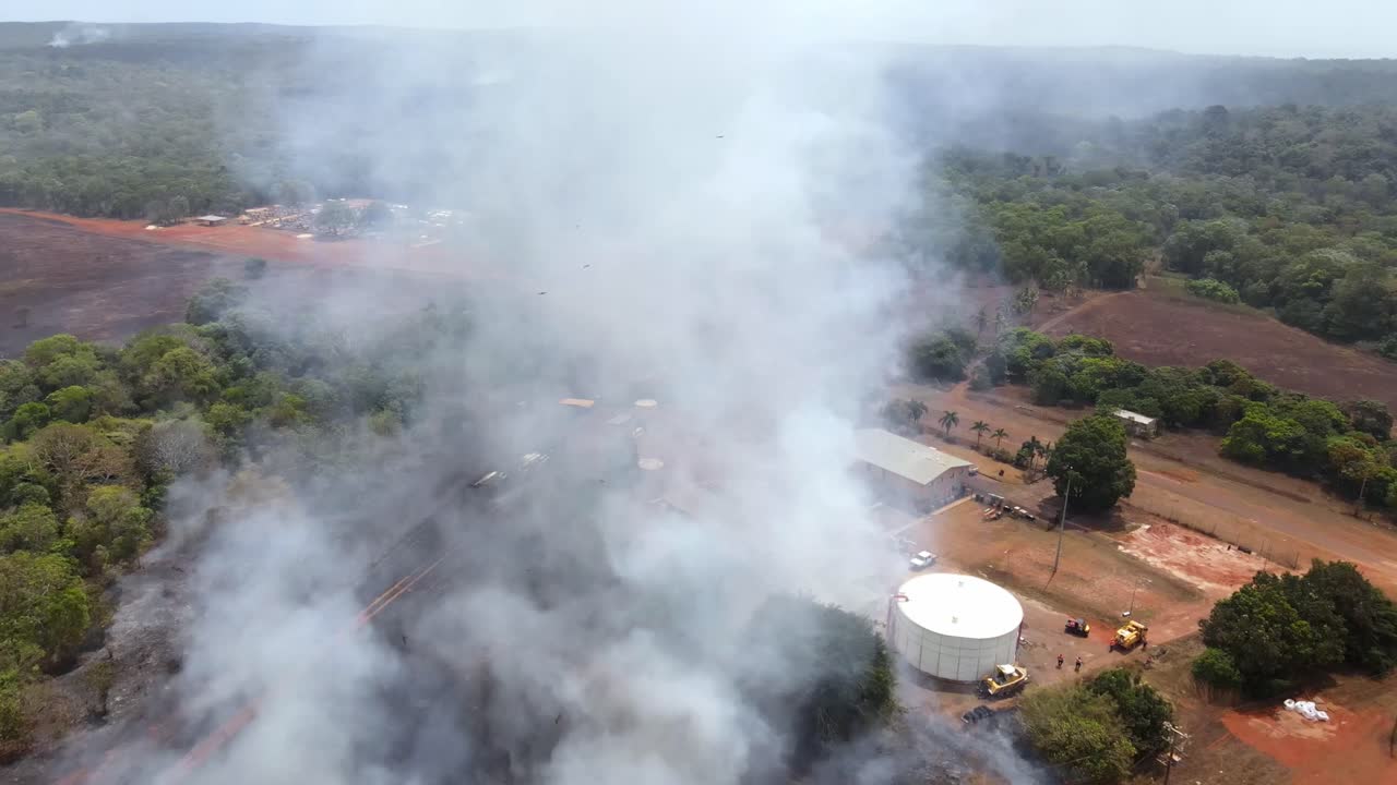 Aerial clip of a wild grass fire and smoke at the edge of a remote community in Cape York, Australia. Clip 3
