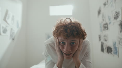 portrait of patient smiling insanely at camera in psychiatric ward