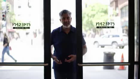 a man enters a store with a calm demeanor, transitioning from the vibrant outside world into a welcoming interior space filled with natural light and energy.