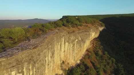 aerial view of a mountain cliff with people