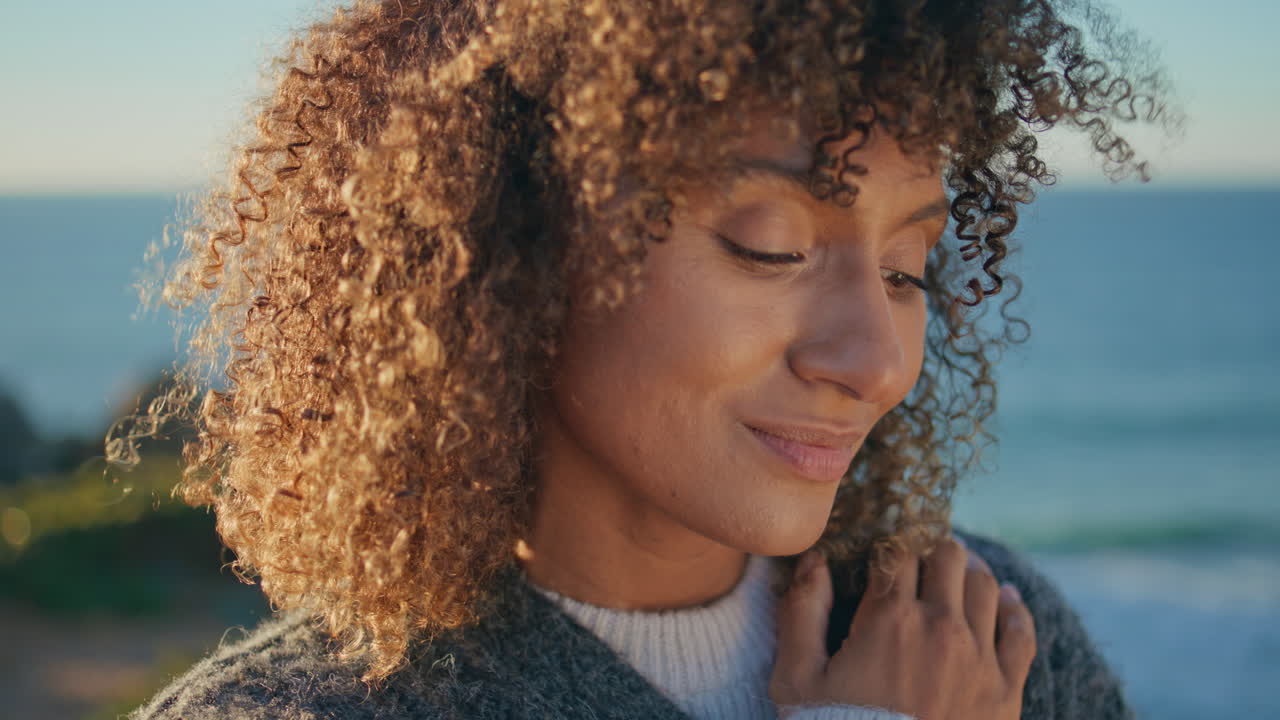 Closeup dreamy girl looking camera at ocean. Portrait   woman