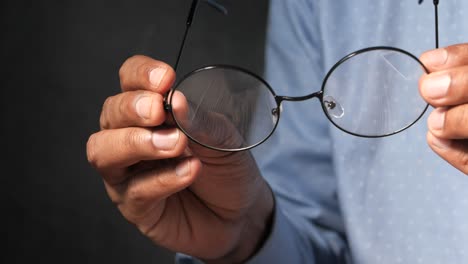 person holding round glasses