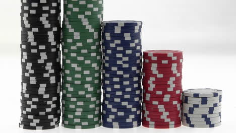 stacks of poker chips sit in a row arranged by value