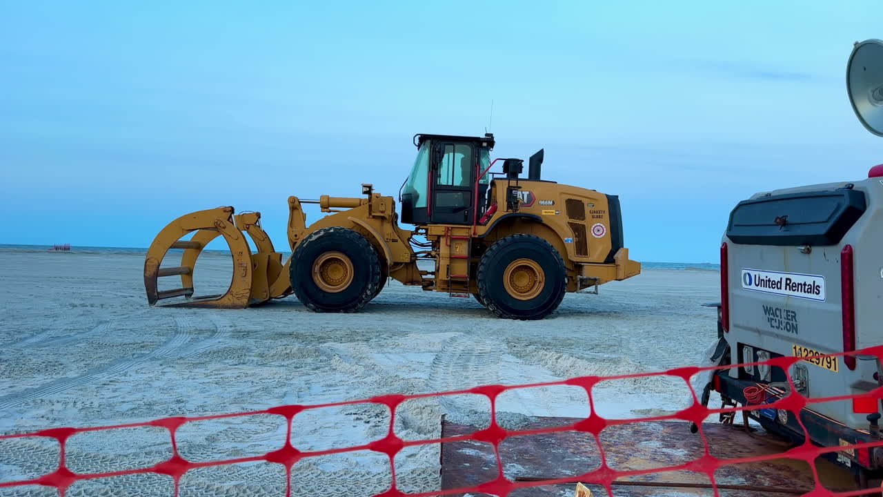 Construction equipment parked on beach during sand replenishment