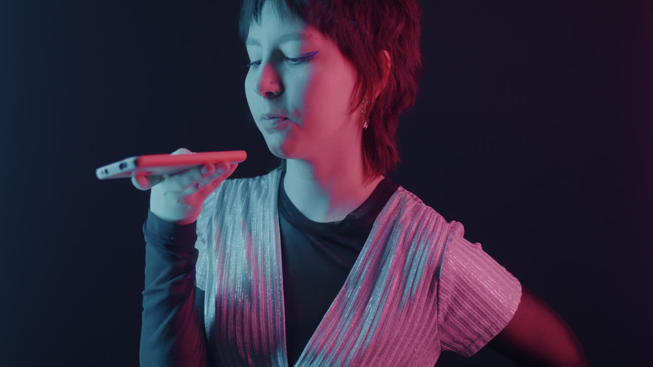 Woman Talking to Smartphone in Neon Lighting