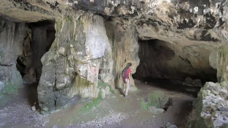 brunette hiker explores murciélago cave in sierra calderona